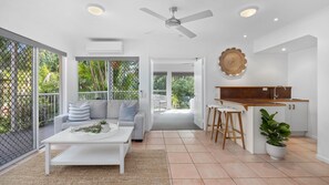 Relax in this stylish space with a seating area, kitchenette, and large window.