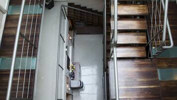A staircase with wooden steps and metal railings, leading to an upper floor.