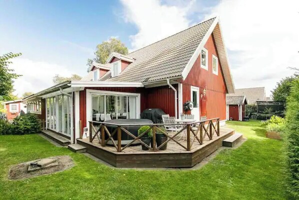 Enjoy outdoor dining and social gatherings on the deck with a grill and comfortable seating.