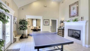A spacious room with a ping pong table, a fireplace, and a large plant. - Free bikes/pools/tennis/fitness Walk 2 pier/village shops & restaurants! (St Simons Island)