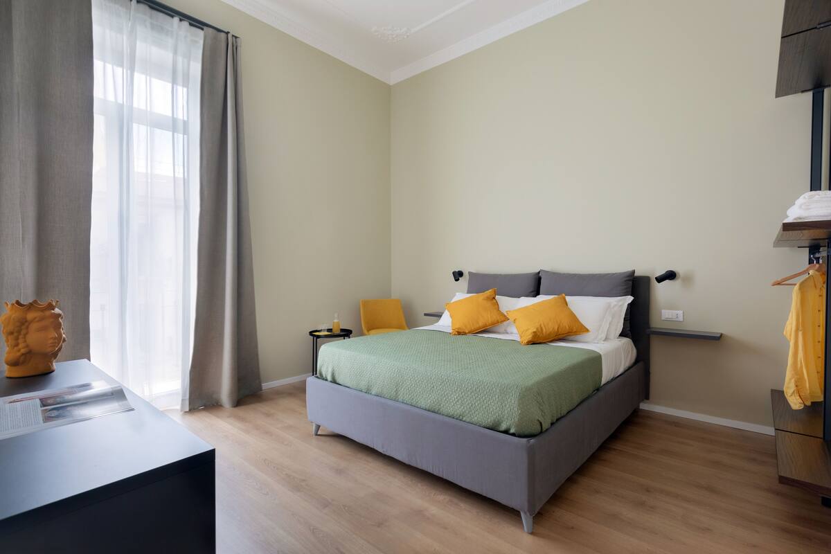 Une chambre à coucher moderne avec un lit, des tables de chevet et une commode.