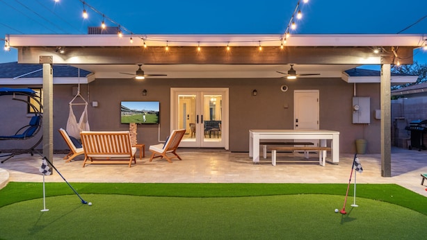 A covered patio with artificial lighting, a pool table, and outdoor seating. - Pool & Art Lover Oasis near Old Town w/ Mini Golf (Scottsdale)