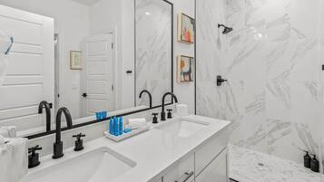 Bathtub, hair dryer, towels, shampoo