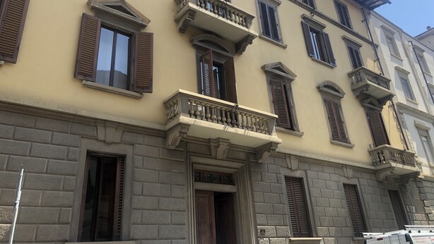 A multi-story building with traditional architecture, featuring balconies with railings and shutters, and a stone facade. - Fortezza Fourth Floor 4 Pax (Firenze)