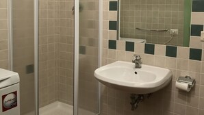 A bathroom with a glass-enclosed shower, a sink with a mirror above it, and a toilet. - Alfani second floor - Three Bedroom Apartment, Sleeps 5 (Firenze)