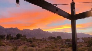 A desert landscape with mountains in the background and a small building in the foreground. - >>MAGICAL property on 5 acres in the Alabama Hills (Lone Pine)