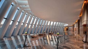 A spacious interior with a curved ceiling, large windows, and a polished wooden floor. - Wyndham Grand Shanxi Xiaohe Xincheng (Taiyuan)