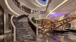A modern interior with a curved staircase, a skylight, and a wooden structure. - Wyndham Grand Shanxi Xiaohe Xincheng (Taiyuan)