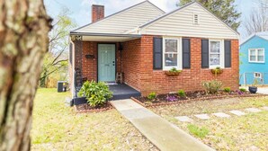 A single-story brick house with a front porch, a mailbox, and a small garden. - Single-Level Kingsport Home · Sleeps 6 · Pets OK (Kingsport)