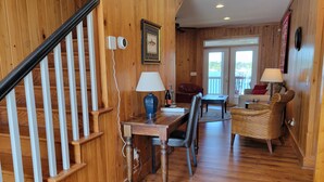 A wooden interior with a staircase, dining area, and a view through a door. - Lake Marion's Big Red House. W/ Dock and Kayaks. Pet Friendly please read policy (Manning)