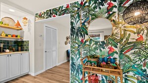 A kitchen with white cabinets, a wooden countertop, and a tiled backsplash. - Boutique style Apt/Walk to Beach/Pet friendly (Indian Harbour Beach)