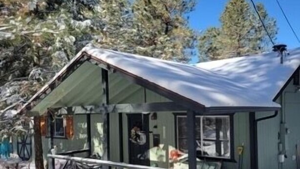 A cabin with a metal roof, large windows, and a porch area. - A/C! Cabin in Strawberry Cool for Summer. Warm for Winter, Elk, and Relax. (Pine)