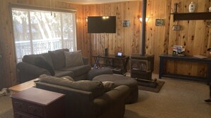 A cozy living room with a fireplace, a television, and a wooden interior. - A/C! Cabin in Strawberry Cool for Summer. Warm for Winter, Elk, and Relax. (Pine)