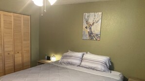 A bedroom with a bed, nightstands, a lamp, a painting, and a wardrobe. - A/C! Cabin in Strawberry Cool for Summer. Warm for Winter, Elk, and Relax. (Pine)