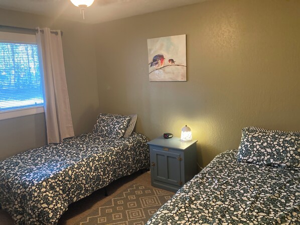 A room with two beds, a nightstand with a lamp, a painting on the wall, and a window with blinds. - A/C! Cabin in Strawberry Cool for Summer. Warm for Winter, Elk, and Relax. (Pine)