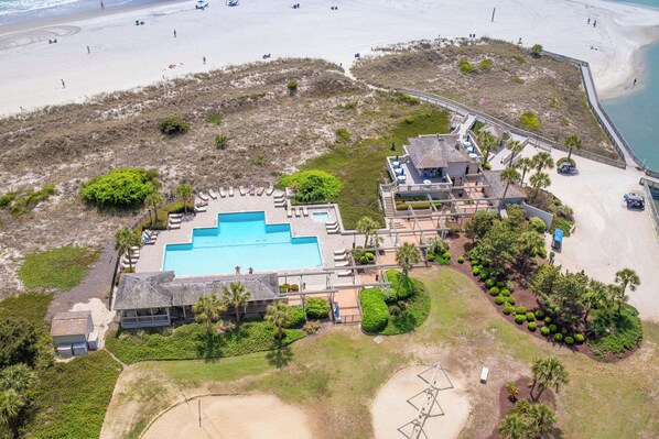 An aerial view of a resort with a swimming pool, beach access, and a large building with multiple rooms. - Beautiful 2 Bedroom Tennis Villa in Ocean Creek (Myrtle Beach)