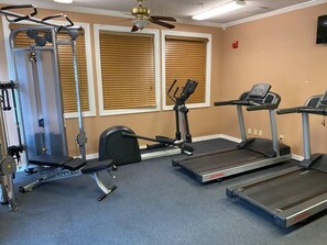 A gym with treadmills, a stationary bike, and weight machines.