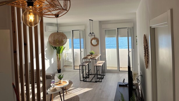 A modern living room with a large window, a dining area, and a view of the sea. - BALERMA BEACH (El Ejido)