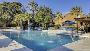Relax by the pool surrounded by lounge chairs and shaded seating options.