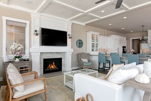 Smart TV, fireplace, books, computer monitors
