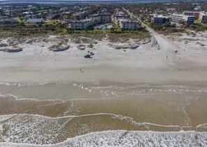 An aerial view of a coastal area with a beach, buildings, and a road. - NEW LISTING ~ Spectacular Ocean Views ~ Professionally Decorated (Saint Augustine)