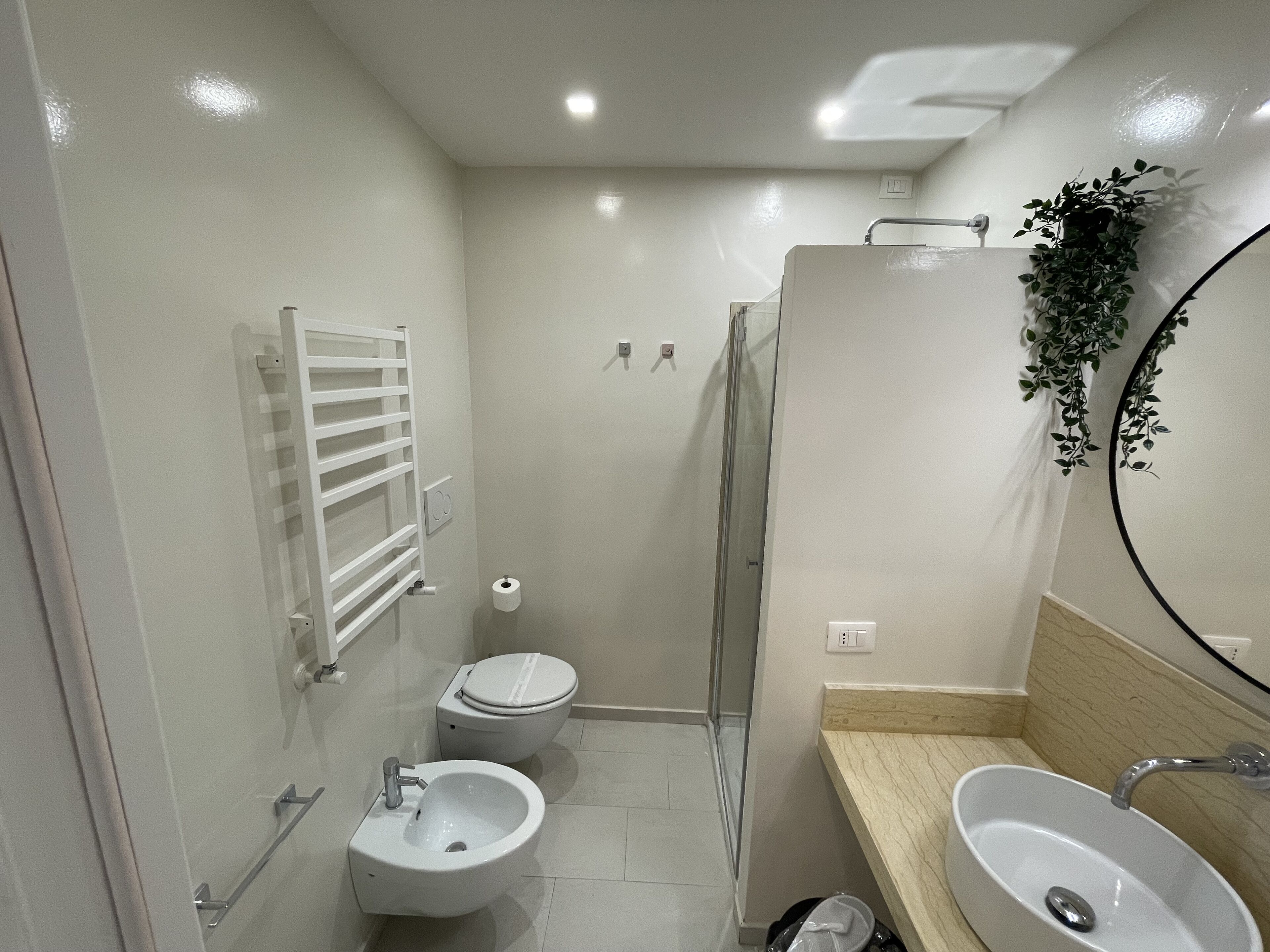A modern bathroom with a toilet, bidet, and sink.