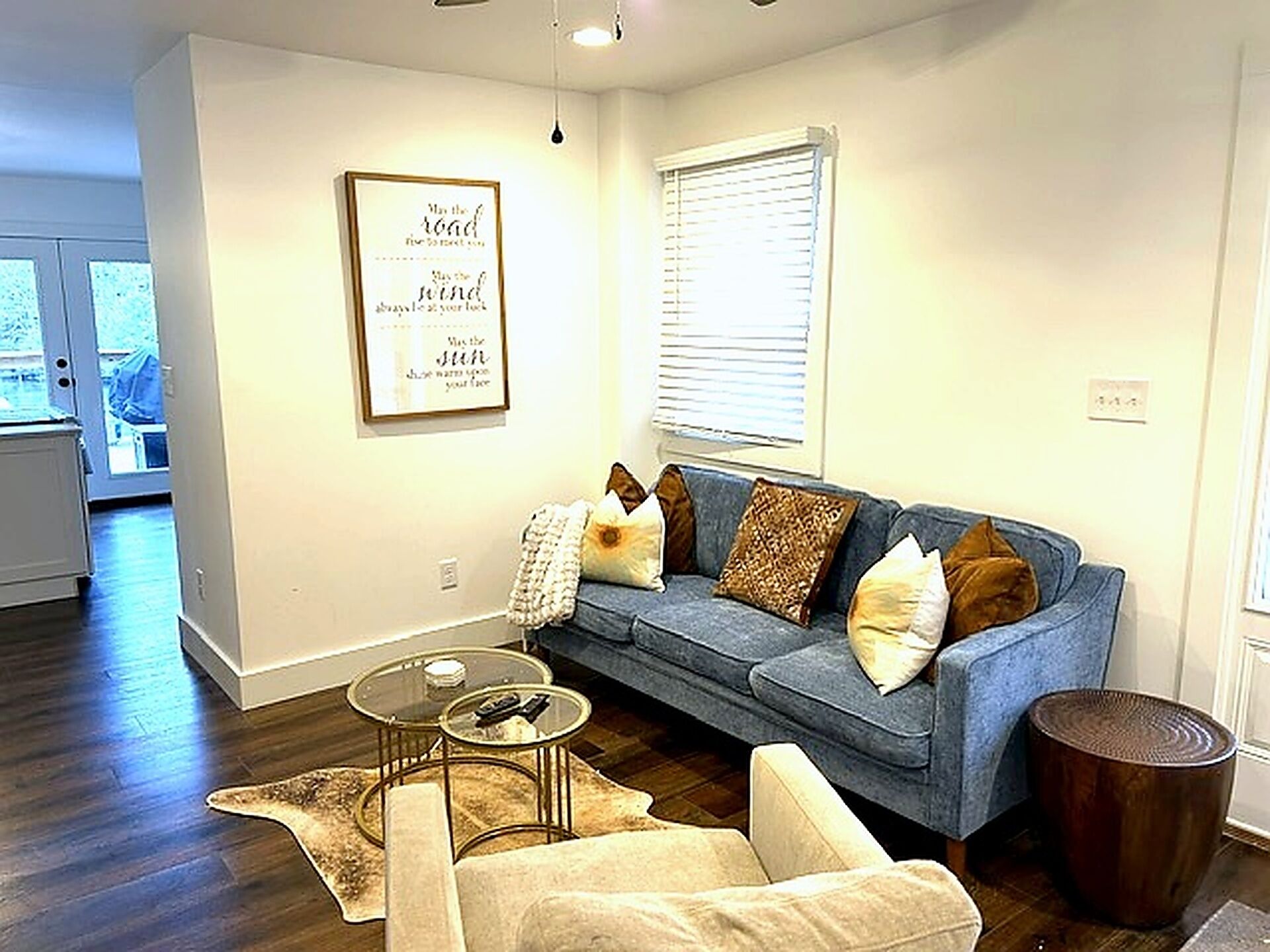 A living room with a sofa, a coffee table, and a rug.