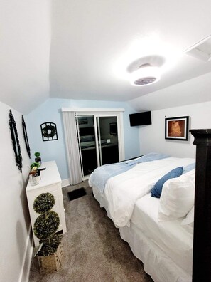 A bedroom with a bed, a dresser, a TV, and a window with curtains. - Toledo, lakeside home 3 bdrm sleep 7 on Lake Erie with 4 decks
to choose from. (Toledo)