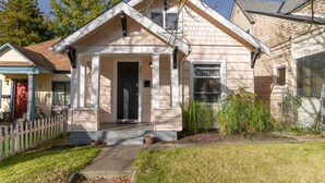 A single-story house with a front porch, a visible mailbox, and a small front yard.