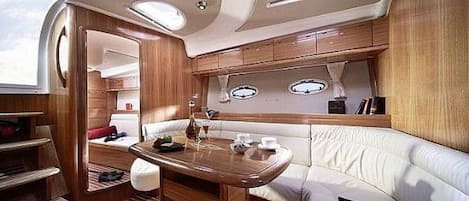 A compact, well-lit interior with a dining area, seating, and a small kitchenette.