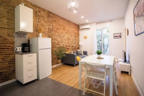 A compact living space with a kitchen, dining area, and seating area.