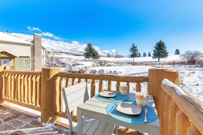 Enjoy a serene winter scene from this deck, overlooking snow-covered grounds and distant trees.