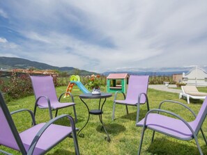 Relax in a serene outdoor space with a seating area, complete with a table and four chairs.