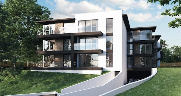 A modern multi-story house with large windows, a flat roof, and a sloped driveway.