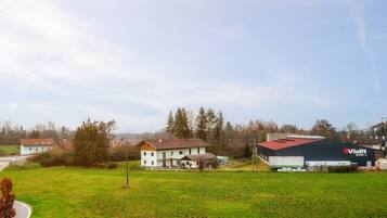 A rural landscape with a large industrial building labeled "Vialit Werk 2" and several residential houses.
