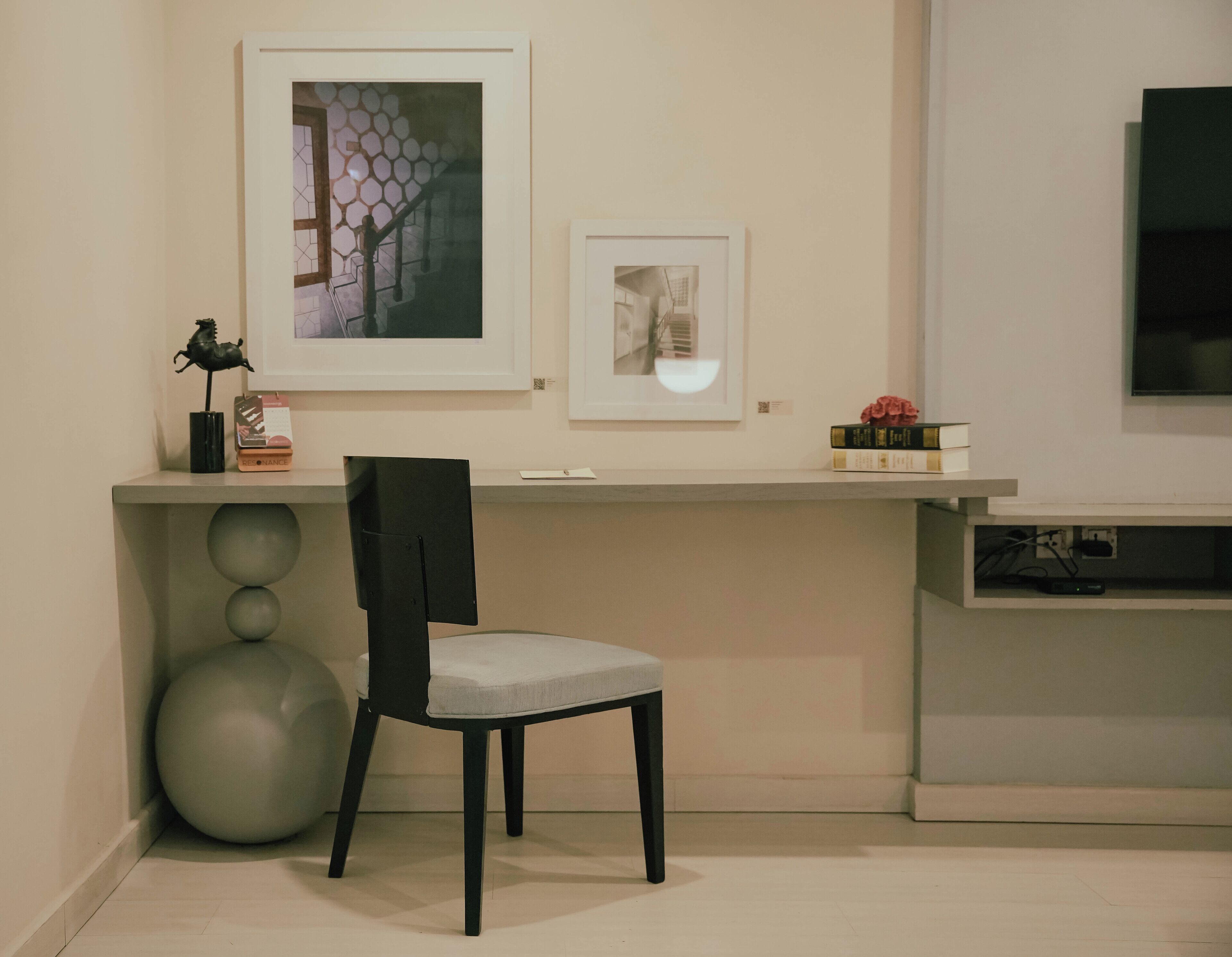 A modern room with a desk, chair, and a large exercise ball.