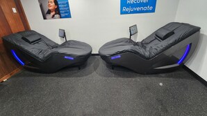 A room with two massage chairs, a poster on the wall, and a sign that reads "Relax Recover Rejuvenate". - Ramada Bayside Inn & Suites Eureka (Eureka)