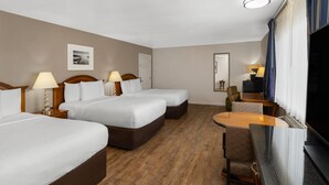 A hotel room with two beds, a television, a desk, and a chair. - Ramada Bayside Inn & Suites Eureka (Eureka)