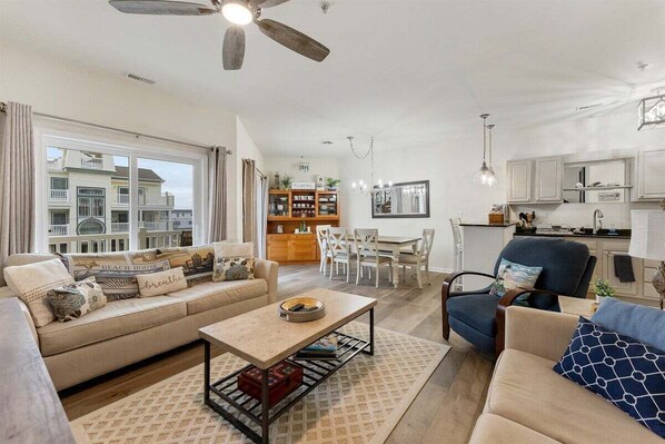 A living room with a sofa, coffee table, and dining area.