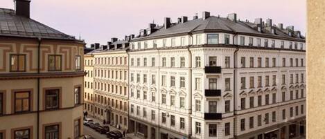 A multi-story building with a classical architectural style, featuring a symmetrical facade with evenly spaced windows and a central entrance.