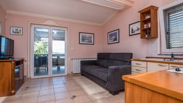 Comfort Apartment A1 | Living area | 100-cm flat-screen TV with satellite channels, TV
