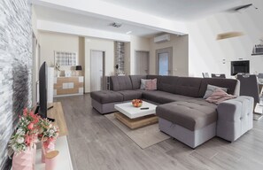 Family Villa | Living area | 100-cm flat-screen TV with satellite channels, TV