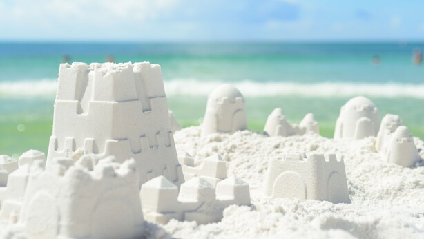 A beach with sandcastles and a clear view of the ocean. - Florida Cottage | Fenced yard| Serentiy Cottage | Hot Tub | Santa Rosa Beach (Santa Rosa Beach)