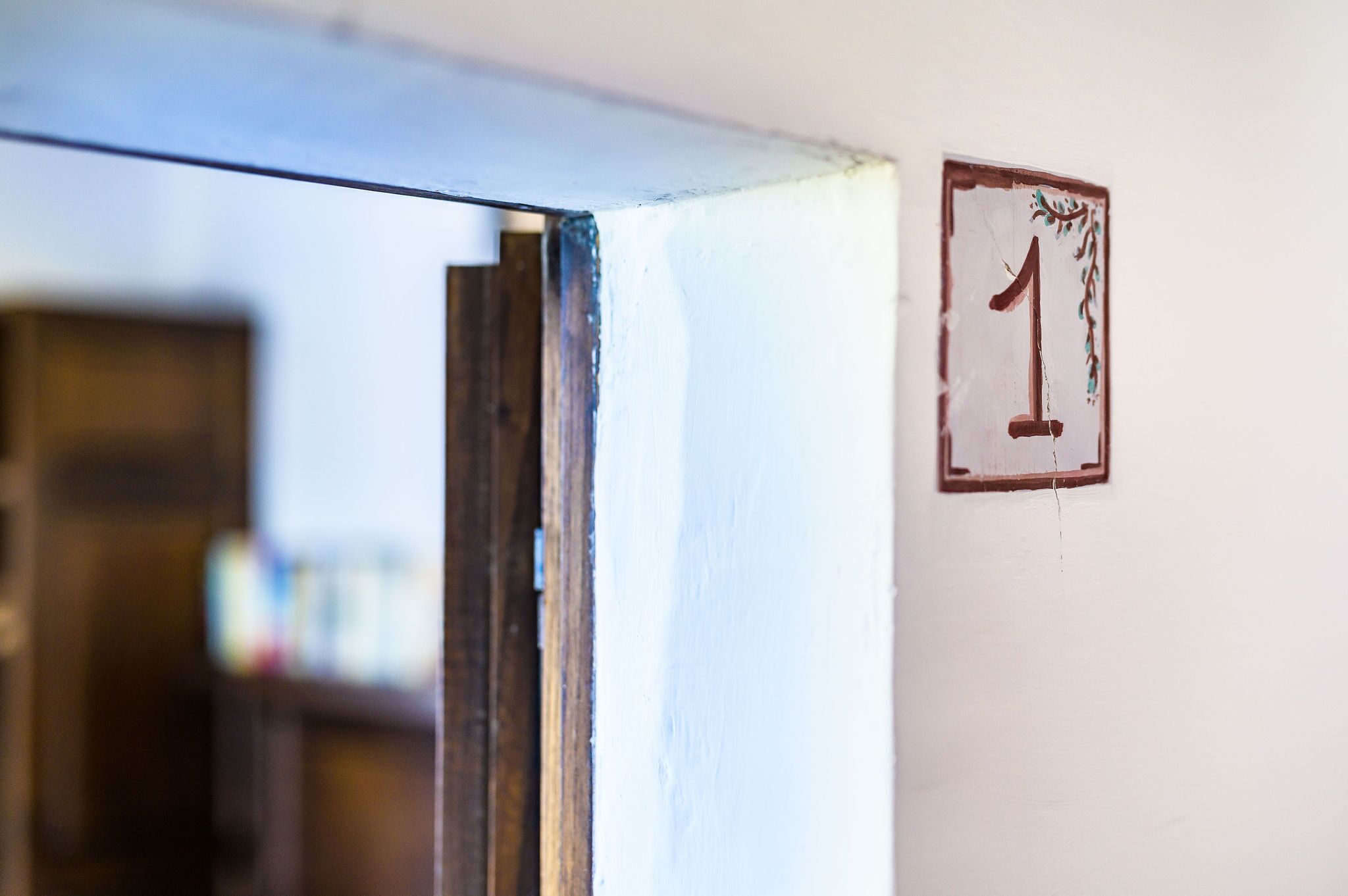 A door frame with a number '1' sign on the wall.