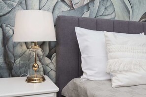 Cozy retreat with a stylish bed and elegant bedside table.