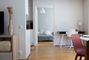 Relax in a serene space with a comfortable bed, workspace, and seating area.