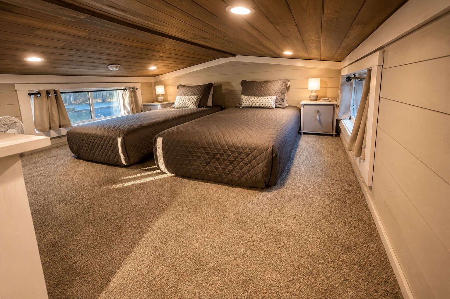 A bedroom with two beds, a nightstand, a bedside table, and a window with curtains.