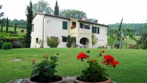 A two-story house with a garden in front.