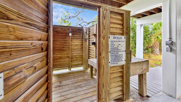 A wooden spa area with a sign listing rules. - Welcome to Waterbird Watch! (St. George Island)