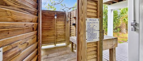 A wooden spa area with a sign listing rules.